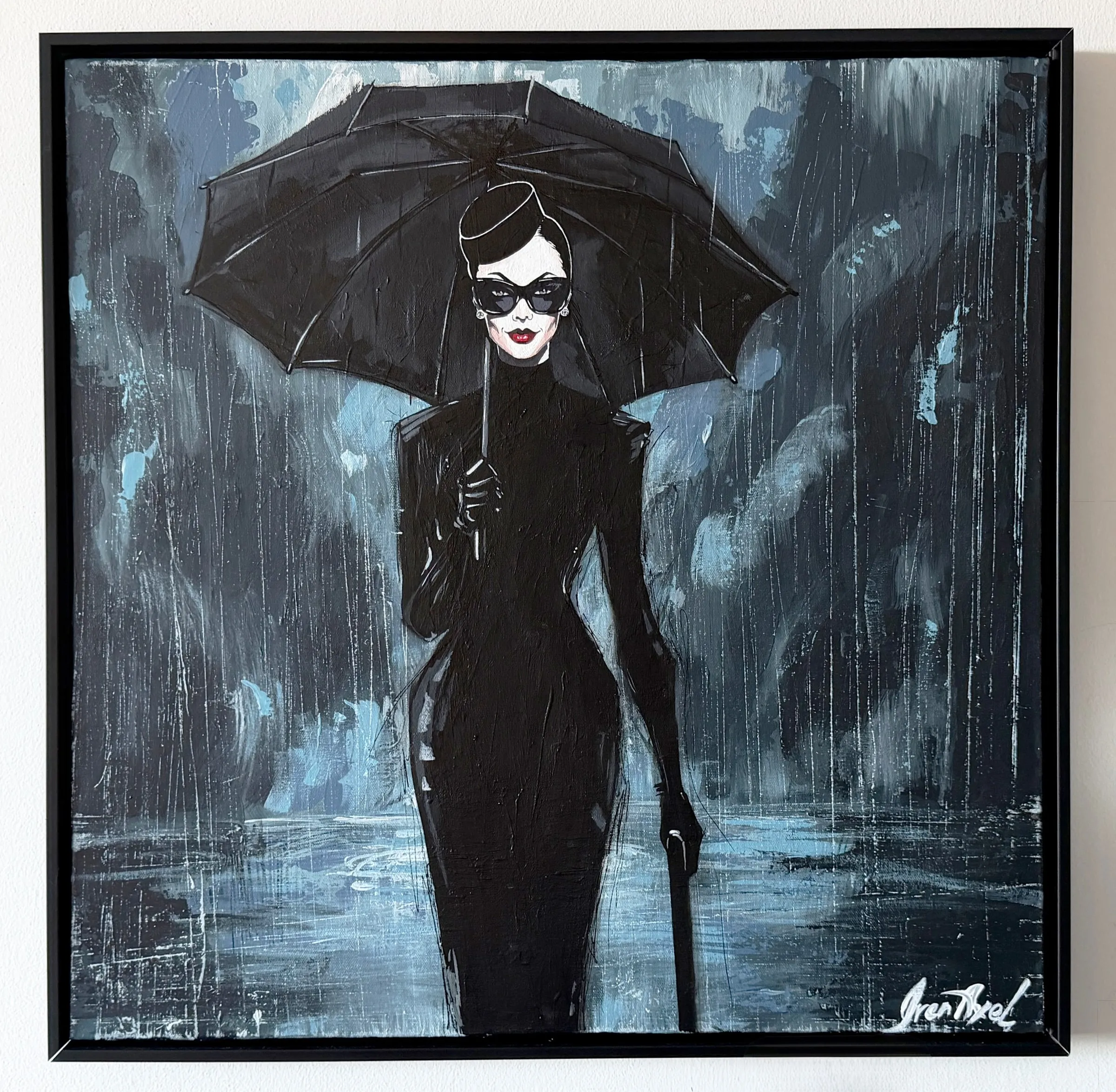 Framed: a woman in a black dress and sunglasses under a black umbrella in the rain